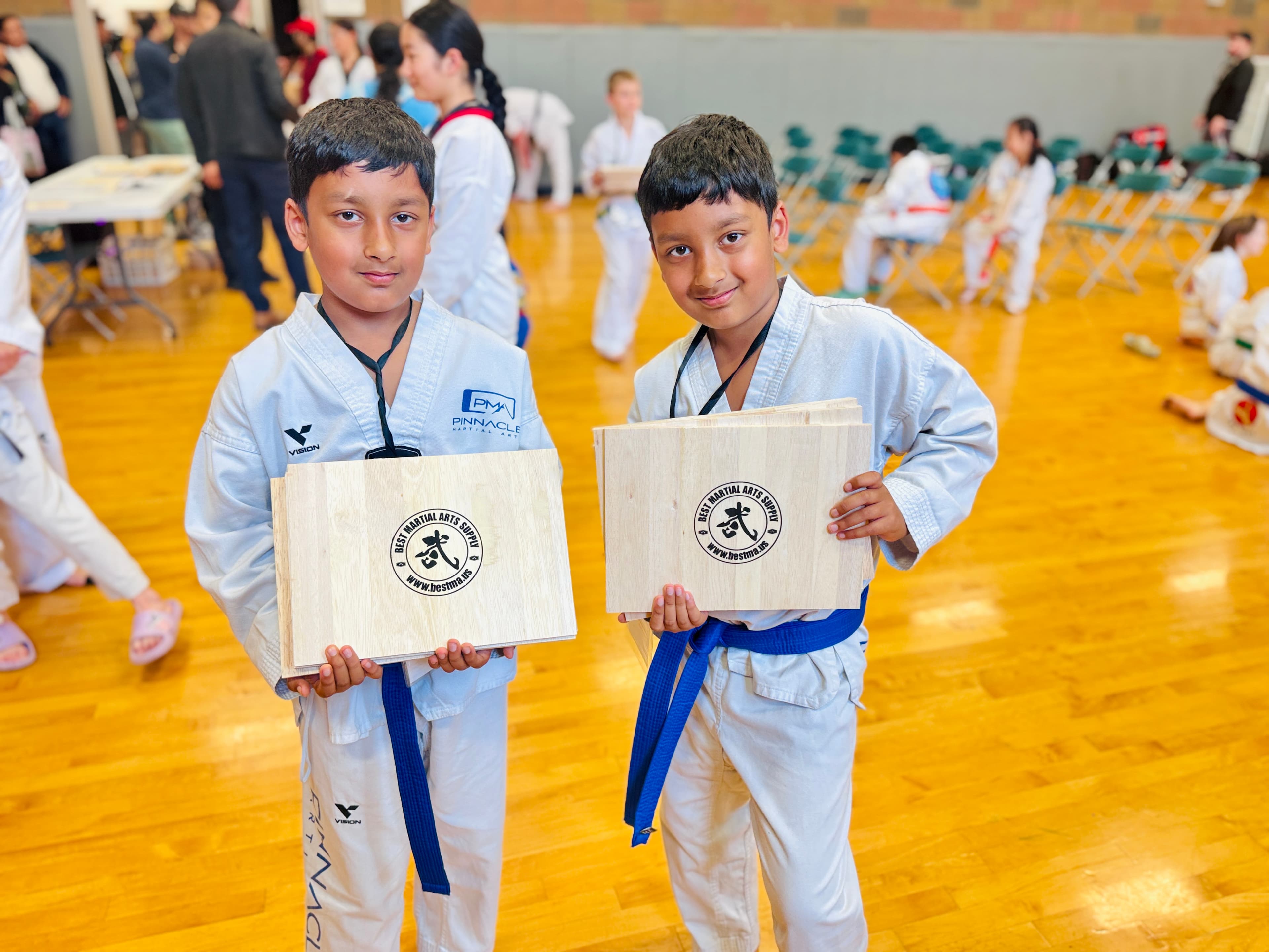 Twin Tiger martial arts class practicing on mats